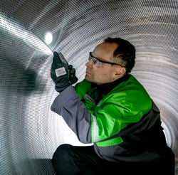 Inspection of suction roll shell by Valmet service engineer