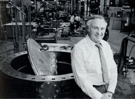 Howard G. Freeman on the manufacturing floor at Jamesbury Corporation with one of the company’s larger butterfly valves