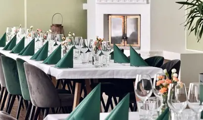 Long table dinner seating with glassware and tableware in a restaurant