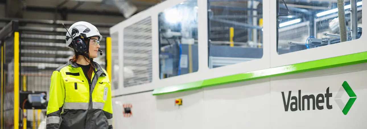 Valmeteers standing next to a molded fiber production line