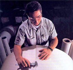 Winder expert performing gap test on wound roll