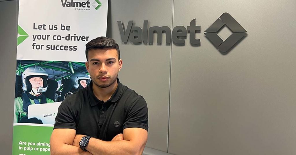 Trainee standing in front of Valmet signs in Spain