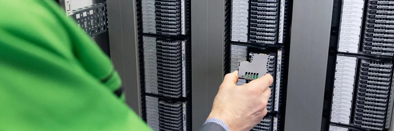 A field technician changing a single-channel I/O card for a distributed control system (DCS)