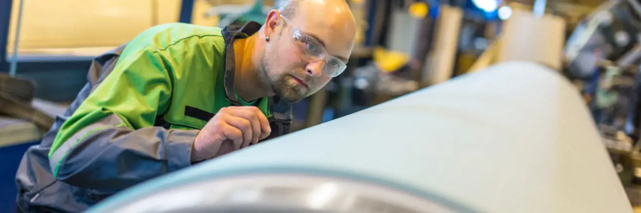 Roll service center - technician inspecting a roll